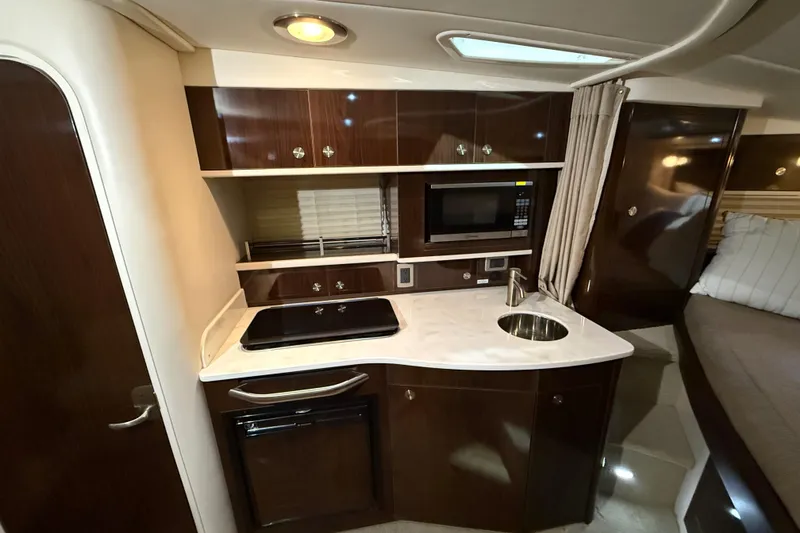 Slide: The Image of Interior of 2017 Sea Ray Sundancer 330 yacht with modern seating and wooden steps. - 55