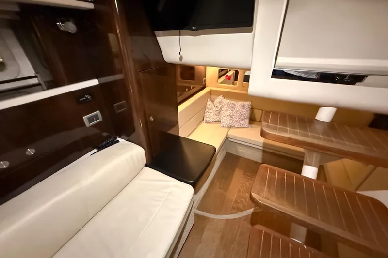 Slide: The Image of 2017 Sea Ray 330 Sundancer bathroom with toilet, shelves, and wooden floor. - 65