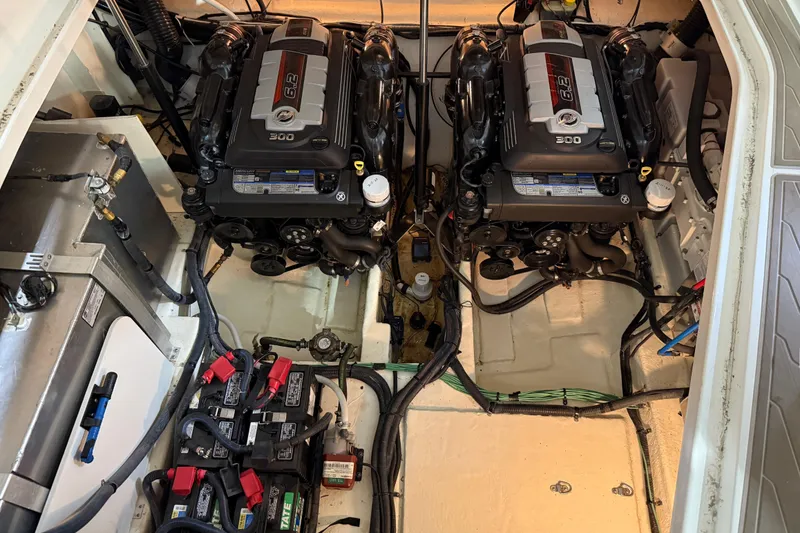 Slide: The Image of Engine compartment of a 2017 Sea Ray Sundancer 330 with batteries and mechanical components. - 71