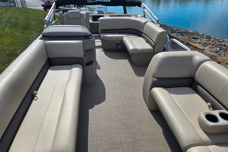 Slide: The Image of 2024 Sun Tracker Party Barge 18 DLX interior with spacious seating and cup holders. - 11