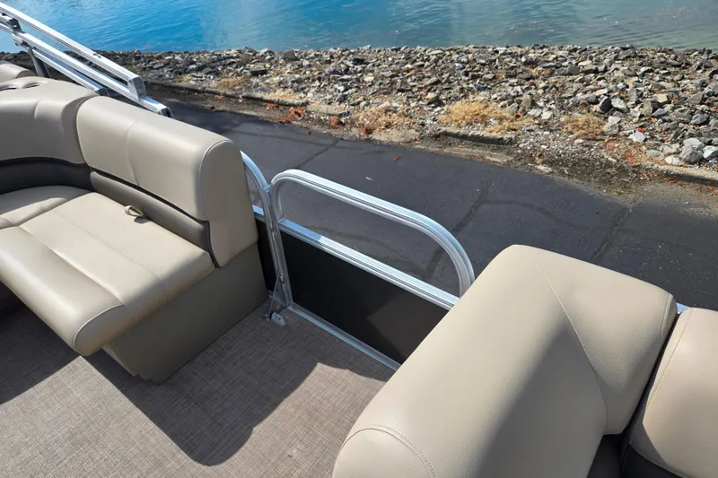 Slide: The Image of 2024 Sun Tracker Party Barge 18 DLX with beige seating by the water. - 12