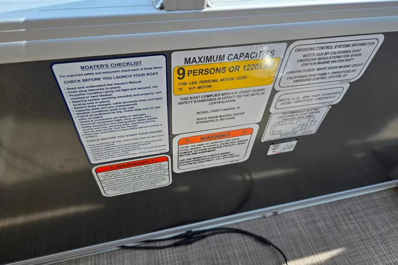 Slide: The Image of 2024 Sun Tracker Party Barge 18 DLX capacity and safety labels on boat interior. - 14