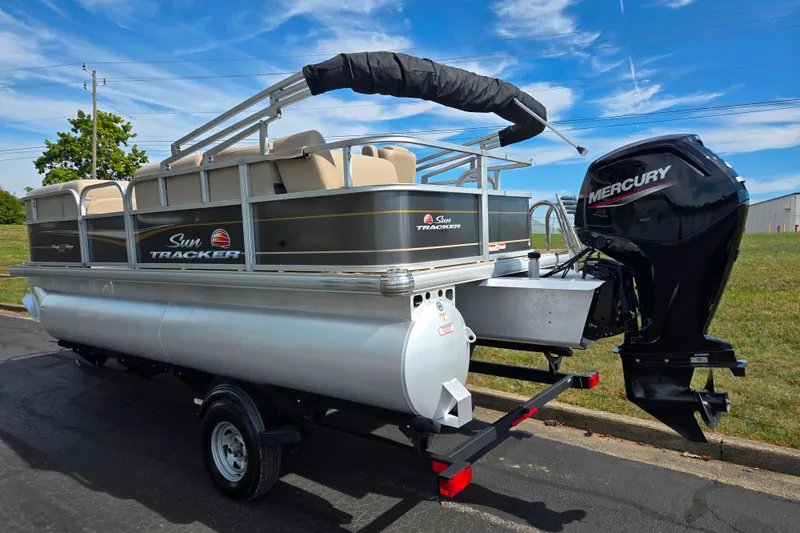 Slide: The Image of 2024 Sun Tracker Party Barge 18 DLX pontoon boat with Mercury outboard motor on trailer. - 3