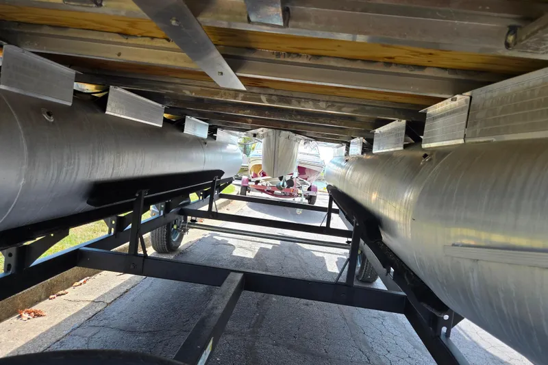 Slide: The Image of Underneath view of 2024 Sun Tracker Party Barge 18 DLX pontoon boat on trailer. - 7