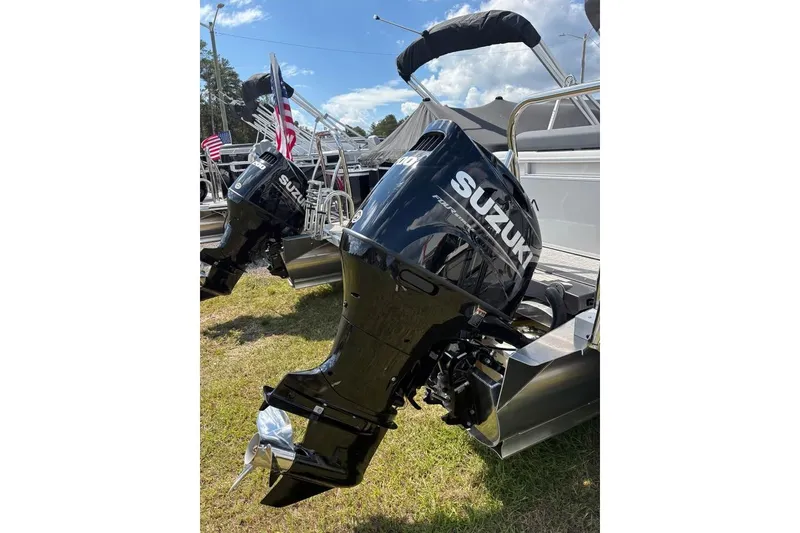 Slide: The Image of 2025 Avalon LSZ Entertainer with Suzuki outboard motors, displayed outdoors on grass. - 11