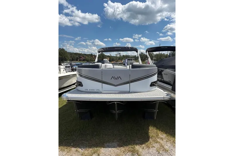 Slide: The Image of 2025 Avalon LSZ ENTERTAINER pontoon boat under a blue sky with clouds. - 12