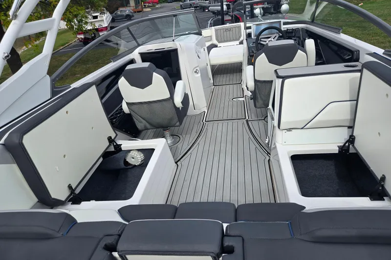 Slide: The Image of 2021 Yamaha Boats 252S interior with open storage compartments and seating. - 10