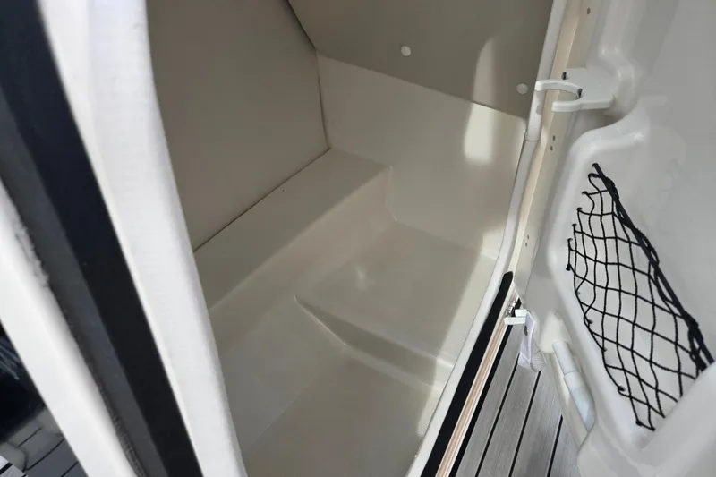 Slide: The Image of 2021 Yamaha Boats 252S interior storage compartment with netted pocket and sleek design. - 12