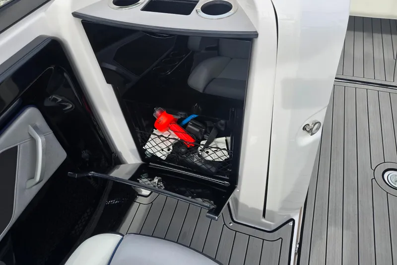 Slide: The Image of 2021 Yamaha Boats 252S storage compartment with safety gear and accessories. - 13