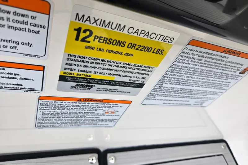 Slide: The Image of 2021 Yamaha Boats 252S capacity label, maximum 12 persons or 2200 lbs, safety warnings. - 16