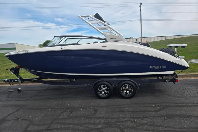 Slide: The Image of 2021 Yamaha Boats 252S on trailer, sleek design, blue and white exterior. - 4
