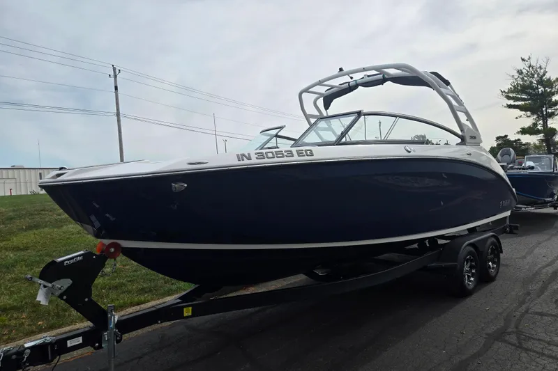 Slide: The Image of 2021 Yamaha Boats 252S on trailer, sleek design, parked outdoors. - 5