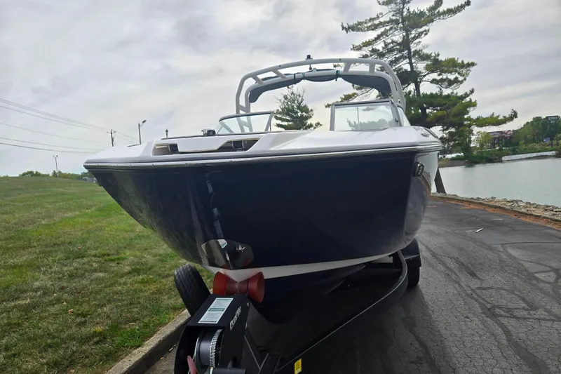 Slide: The Image of 2021 Yamaha Boats 252S on trailer by lakeside, showcasing sleek design and modern features. - 6