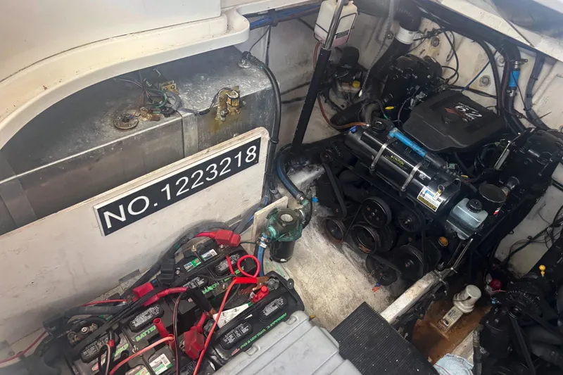 Slide: The Image of Engine compartment of a 2006 Sea Ray 320 Sundancer with visible batteries and engine components. - 11