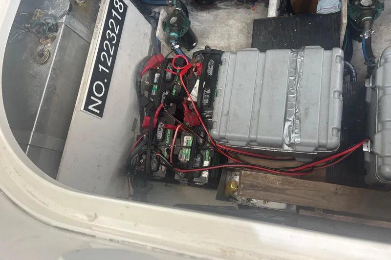 Slide: The Image of Engine compartment of 2006 Sea Ray 320 Sundancer with batteries and wiring visible. - 12