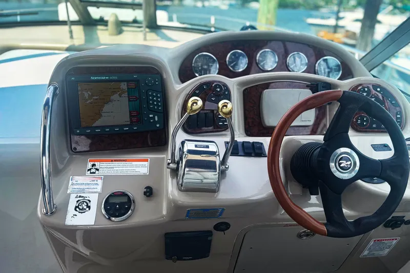 Slide: The Image of Cockpit of 2006 Sea Ray 320 Sundancer with navigation system and steering wheel. - 5