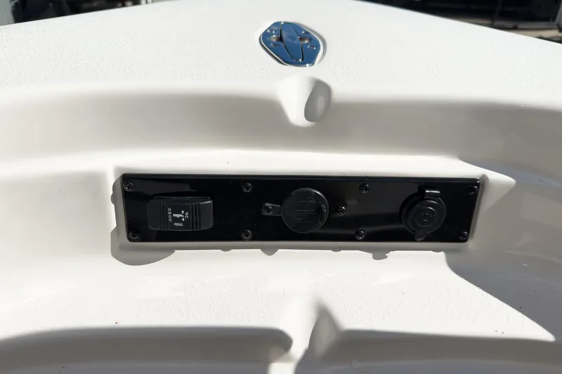 Slide: The Image of 2026 Sea Chaser 26 LX Special Edition boat with powerful outboard motor, docked outdoors. - 16