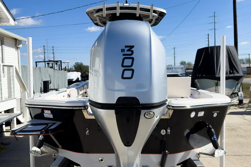 Slide: The Image of 2026 Sea Chaser 26 LX Special Edition boat on trailer, parked in front of a white house. - 3