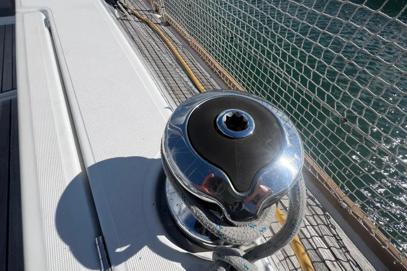 Slide: The Image of Winch on 2012 Beneteau Oceanis 45 sailboat deck, near safety netting and ocean. - 12