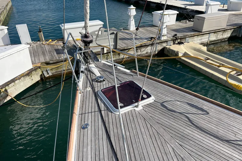 Slide: The Image of Beneteau Oceanis 45 sailboat docked, showcasing deck and marina surroundings, 2012 model. - 14