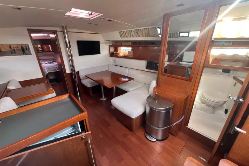 Slide: The Image of Interior of 2012 Beneteau Oceanis 45 yacht with modern furnishings and wood finish. - 16