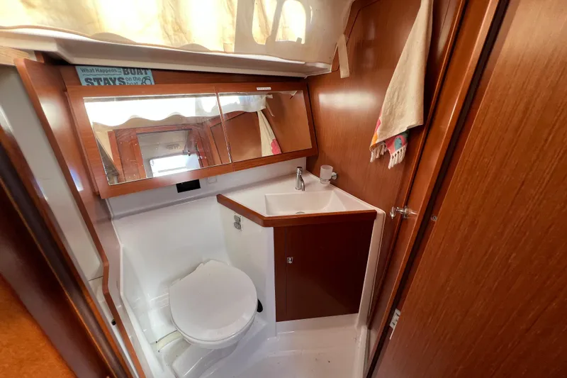 Slide: The Image of Beneteau Oceanis 45 2012 yacht bathroom with wooden cabinetry and compact design. - 19