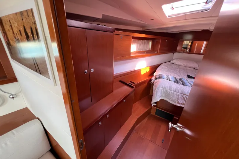 Slide: The Image of Interior cabin of 2012 Beneteau Oceanis 45 yacht with wooden furnishings and cozy bed. - 22
