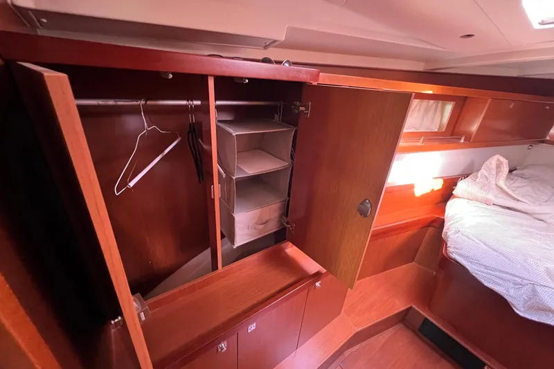 Slide: The Image of Interior of 2012 Beneteau Oceanis 45 showing wooden wardrobe and cozy bed. - 23
