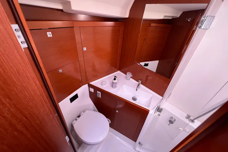 Slide: The Image of Beneteau Oceanis 45 2012 yacht bathroom with wooden cabinetry and modern fixtures. - 25