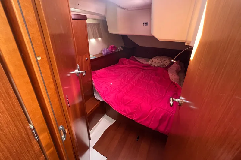 Slide: The Image of Cozy cabin interior of 2012 Beneteau Oceanis 45 with vibrant pink bedding. - 30