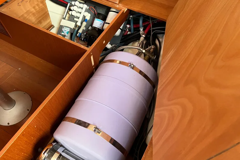 Slide: The Image of Beneteau Oceanis 45 (2012) interior showing mechanical components and storage area. - 33