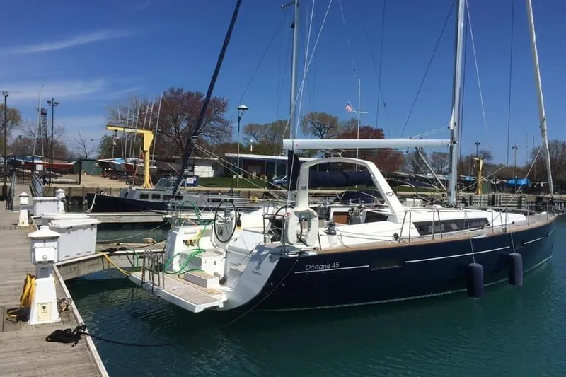 Slide: The Image of 2012 Beneteau Oceanis 45 sailboat docked at marina under clear blue sky. - 39