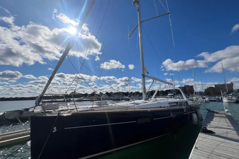 Slide: The Image of 2012 Beneteau Oceanis 45 sailboat docked under a bright blue sky. - 4