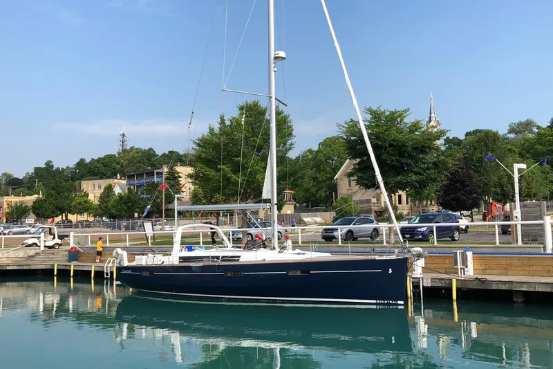 Slide: The Image of 2012 Beneteau Oceanis 45 sailboat docked in a scenic marina setting. - 40