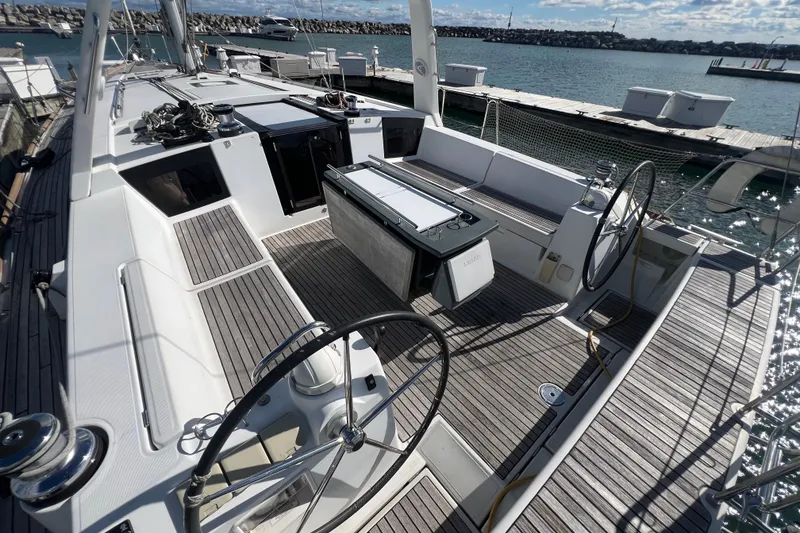 Slide: The Image of 2012 Beneteau Oceanis 45 sailboat cockpit with dual steering wheels and teak decking. - 7