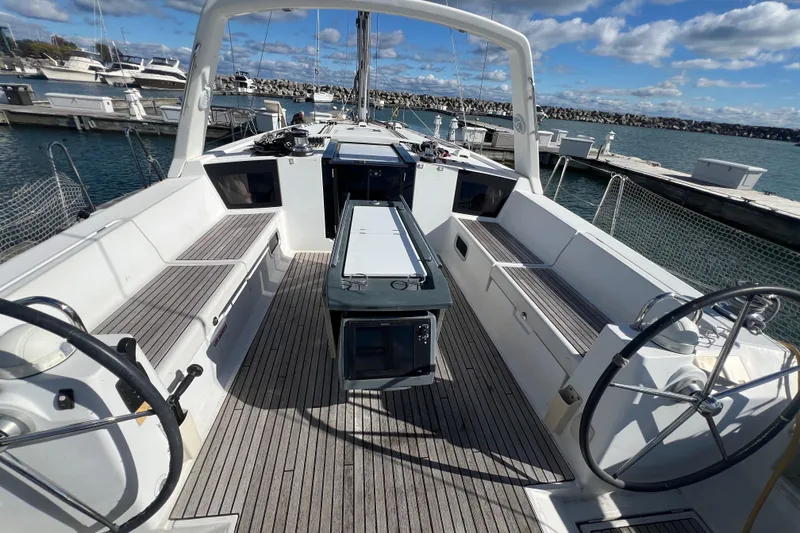 Slide: The Image of 2012 Beneteau Oceanis 45 sailboat cockpit with dual steering wheels and spacious seating. - 8