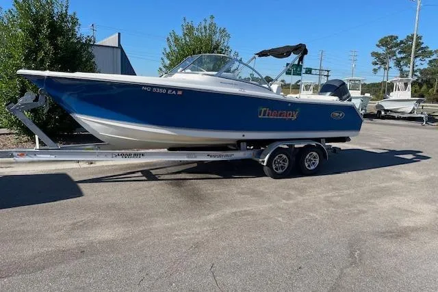 The Image of 2014 Sea Hunt Escape 235 SE boat on trailer in parking lot. - 0
