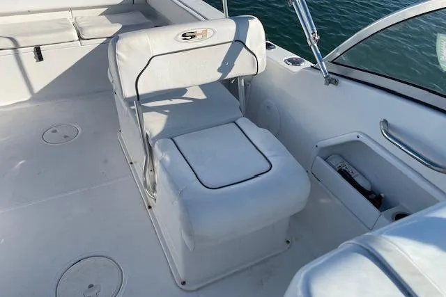 Slide: The Image of 2014 Sea Hunt Escape 235 SE boat interior with white seating and open water view. - 20