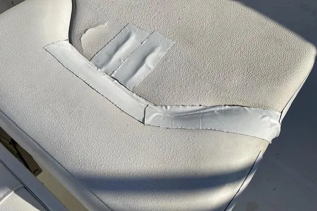 Slide: The Image of Worn seat upholstery on 2014 Sea Hunt Escape 235 SE boat, showing visible repair. - 8