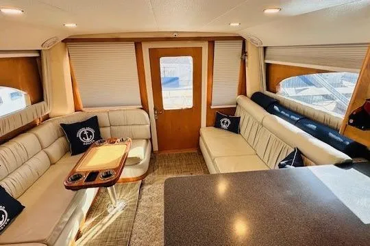 Slide: The Image of Interior of 2001 Luhrs 40 Convertible yacht with cream sofa and nautical-themed pillows. - 4