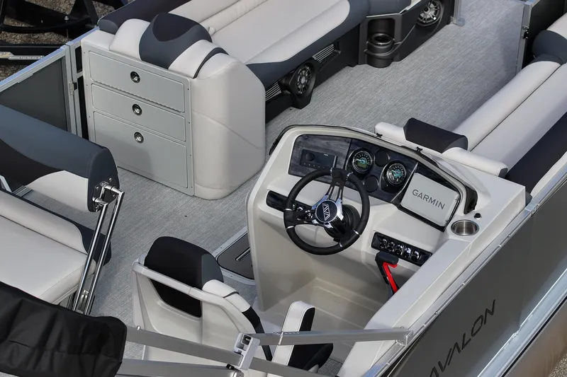 Slide: The Image of 2026 Avalon LSZ Entertainer boat interior with modern helm, seating, and storage. - 3