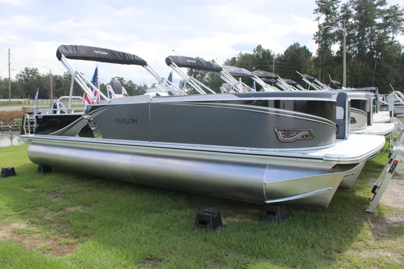 Slide: The Image of 2026 Avalon LSZ Entertainer pontoon boat displayed on grass, featuring sleek design and modern amenities. - 4