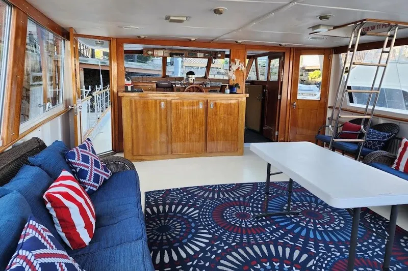 Slide: The Image of Interior of a 1968 Burger Motor Yacht with cozy seating and nautical decor. - 10