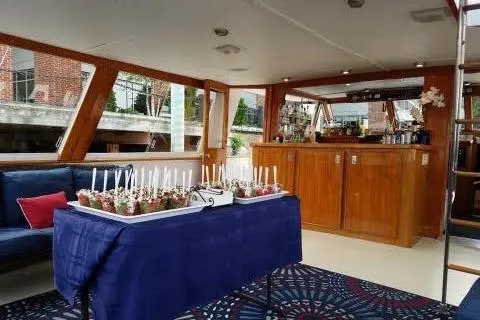 Slide: The Image of Interior of a 1968 Burger Motor Yacht with a table set for a party. - 11