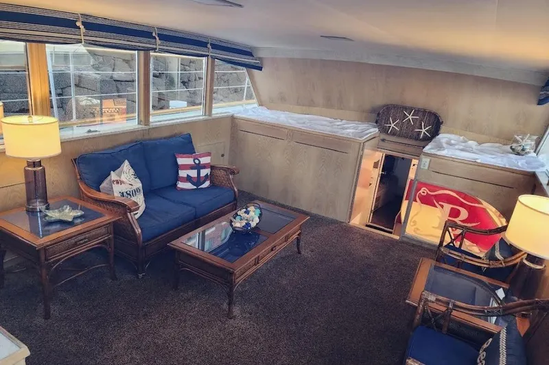 Slide: The Image of Interior of 1968 Burger Motor Yacht with nautical-themed decor and cozy seating area. - 12