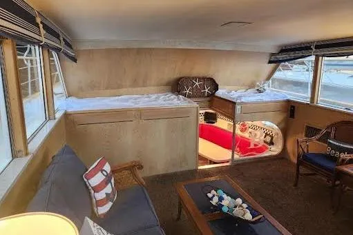 Slide: The Image of Interior of a 1968 Burger Motor Yacht with cozy seating and nautical decor. - 13