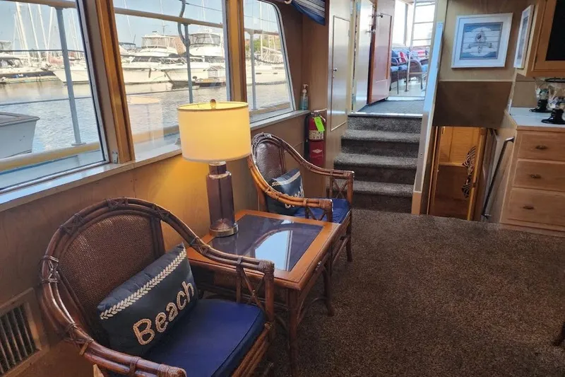 Slide: The Image of Interior of a 1968 Burger Motor Yacht with cozy seating and marina view. - 14