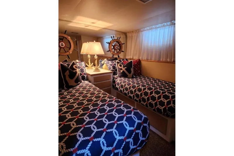 Slide: The Image of Cozy 1968 Burger Motor Yacht cabin with nautical-themed decor and twin beds. - 19