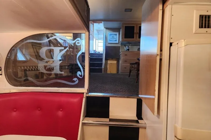 Slide: The Image of Interior of a 1968 Burger Motor Yacht with red seating and wooden cabinetry. - 20