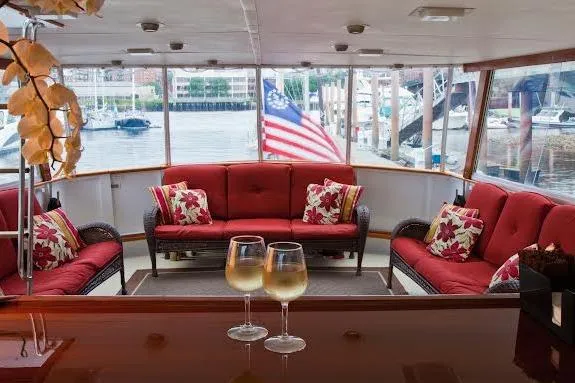 Slide: The Image of Luxurious 1968 Burger Motor Yacht interior with red seating and wine glasses. - 21